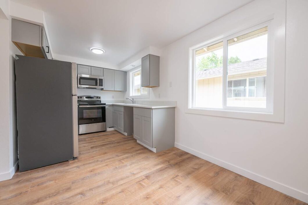 Modern kitchen with stainless steel appliances and window. 278 S Knott St, Canby, OR 97013. Spaces for rent by NWV Group.