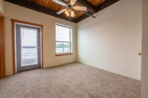 Bedroom with large windows and access to a private balcony. 2808 NE MLK Blvd APT 26, Portland, OR 97212. Spaces for rent by NWV Group.