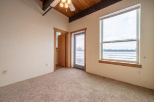 Bedroom with large windows and access to a private balcony. 2808 NE MLK Blvd APT 26, Portland, OR 97212. Spaces for rent by NWV Group.