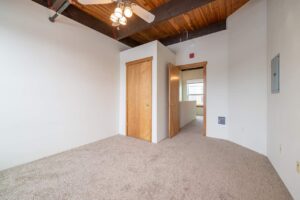 Bedroom with large windows and access to a private balcony. 2808 NE MLK Blvd APT 26, Portland, OR 97212. Spaces for rent by NWV Group.