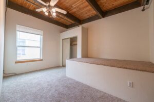 Spacious bedroom with ceiling fan and hallway access. 2808 NE MLK Blvd APT 26, Portland, OR 97212. Spaces for rent by NWV Group.