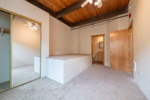 Bedroom with ceiling fan and large windows for natural light. 2808 NE MLK Blvd APT 26, Portland, OR 97212. Spaces for rent by NWV Group.