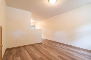 Spacious room with light wood flooring. 4616 NE Irving St #4614, Portland, OR 97213. Spaces for rent by NWV Group.