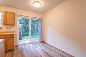 Dining area with sliding door to yard. 4616 NE Irving St #4614, Portland, OR 97213. Spaces for rent by NWV Group.