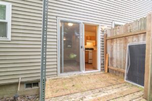 Backyard deck with sliding door to kitchen. 4616 NE Irving St #4614, Portland, OR 97213. Spaces for rent by NWV Group.