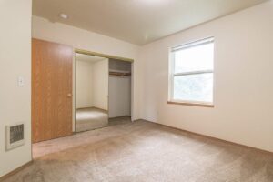 Bedroom with closet and window. 4616 NE Irving St #4614, Portland, OR 97213. Spaces for rent by NWV Group.