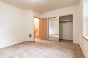 Bedroom with mirrored closet doors. 4616 NE Irving St #4614, Portland, OR 97213. Spaces for rent by NWV Group.