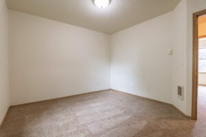 Bedroom with neutral walls and window. 4616 NE Irving St #4614, Portland, OR 97213. Spaces for rent by NWV Group.