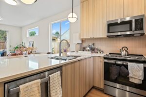 Kitchen island with sink and view of open living space. 6417 N Greeley Ave #4, Portland, OR 97217. Spaces for rent by NWV Group.