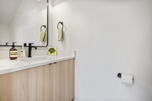 Bathroom with light wood cabinetry and sleek black accents. 6417 N Greeley Ave #4, Portland, OR 97217. Spaces for rent by NWV Group.