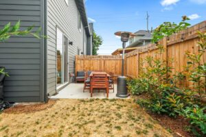 Backyard patio with wooden dining set and heater. 6417 N Greeley Ave #4, Portland, OR 97217. Spaces for rent by NWV Group.