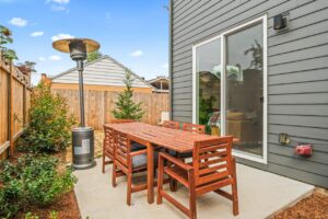 Outdoor patio with dining set and sliding door access. 6417 N Greeley Ave #4, Portland, OR 97217. Spaces for rent by NWV Group.