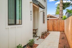 Entry area with address 6417 and small outdoor table set. 6417 N Greeley Ave #4, Portland, OR 97217. Spaces for rent by NWV Group.