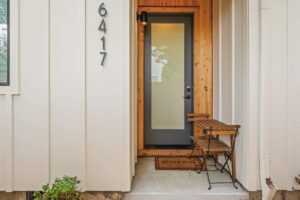 Modern entry with large frosted glass door and outdoor seating. 6417 N Greeley Ave #4, Portland, OR 97217. Spaces for rent by NWV Group.