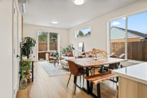 Living room with cozy sectional sofa and sliding door to patio. 6417 N Greeley Ave #4, Portland, OR 97217. Spaces for rent by NWV Group.