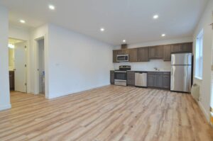 Open kitchen and living area with wood floors. 9572 N Calhoun Ave UNIT B, Portland, OR 97203. Spaces for rent by NWV Group.