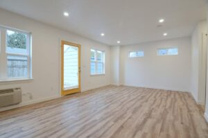 Bright living room with wooden flooring. 9572 N Calhoun Ave UNIT B, Portland, OR 97203. Spaces for rent by NWV Group.