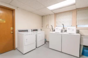 Laundry room with two washers and two dryers. Spaces for rent by NWV Group. 1210 SE 20th Ave APT 103, Portland, OR 97214.