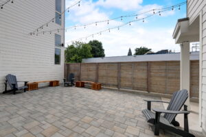 Spacious outdoor patio with string lights, seating, and fenced privacy. Spaces for rent by NWV Group at 4712 N Williams Ave #204.