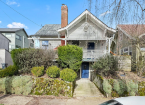 Exterior of house with garden and stairs leading to unit. Spaces for rent by NWV Group. 125 NE Shaver St #B, Portland, OR 97212.