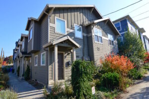 Exterior view of townhouse with garden and sidewalk. Spaces for rent by NWV Group at 6928 N Greenwich Ave APT 2.