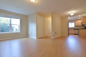 Spacious living room with large windows and light floors. Spaces for rent by NWV Group at 6928 N Greenwich Ave APT 2.