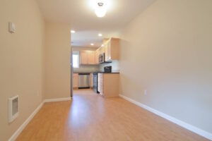 Kitchen area with wooden cabinets and modern appliances. Spaces for rent by NWV Group at 6928 N Greenwich Ave APT 2.