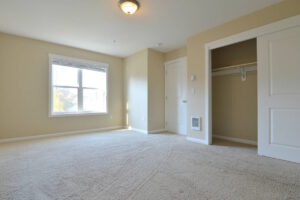 Bedroom with a closet, beige carpet, and two large windows. Spaces for rent by NWV Group at 6928 N Greenwich Ave APT 2.