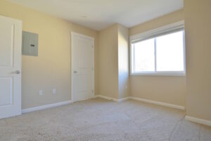 Bedroom with window, closet, and beige walls. Spaces for rent by NWV Group at 6928 N Greenwich Ave APT 2.