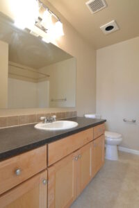 Bathroom with a wide vanity, sink, and tiled counter. Spaces for rent by NWV Group at 6928 N Greenwich Ave APT 2.