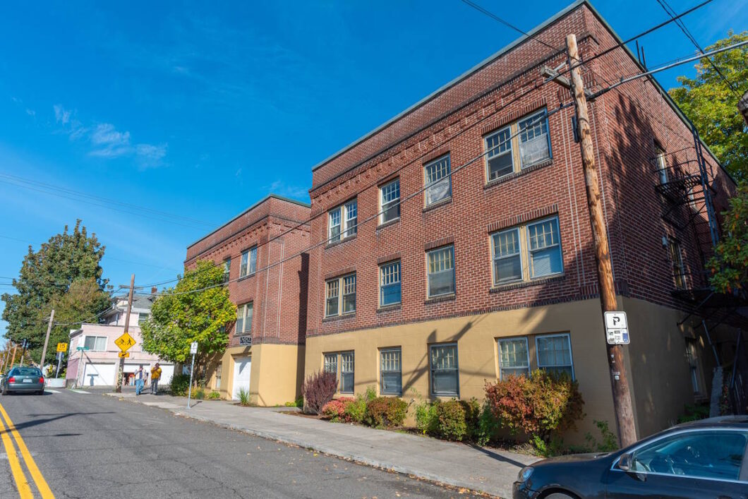 Side view of brick building with sidewalk landscaping. Spaces for rent by NWV Group. 1210 SE 20th Ave APT 103, Portland, OR 97214.