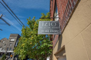 Close-up of Queen Marie Apartments sign. Spaces for rent by NWV Group. 1210 SE 20th Ave APT 103, Portland, OR 97214.