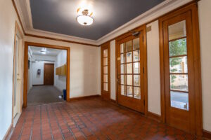 Interior lobby with tiled floor and wooden doors. Spaces for rent by NWV Group. 1210 SE 20th Ave APT 103, Portland, OR 97214.