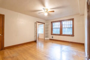 Spacious living room with hardwood floors and ceiling fan. Spaces for rent by NWV Group. 1210 SE 20th Ave APT 103, Portland, OR 97214.