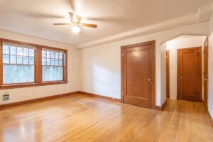 Living room with wood accents, large windows, and closet. Spaces for rent by NWV Group. 1210 SE 20th Ave APT 103, Portland, OR 97214.