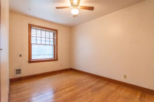 Bedroom with hardwood flooring and ceiling fan. Spaces for rent by NWV Group. 1210 SE 20th Ave APT 103, Portland, OR 97214.