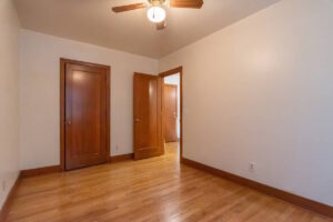 Bedroom with closet doors and wooden trim. Spaces for rent by NWV Group. 1210 SE 20th Ave APT 103, Portland, OR 97214.