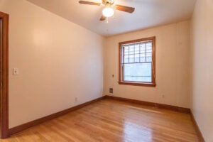 Bedroom with hardwood floors, ceiling fan, and window. Spaces for rent by NWV Group. 1210 SE 20th Ave APT 103, Portland, OR 97214.