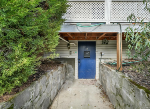 Entrance to basement unit with blue door and garden. Spaces for rent by NWV Group. 125 NE Shaver St #B, Portland, OR 97212.