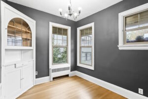 Charming dining area with dark gray walls and chandelier. 2233 NW Flanders St APT 9, Portland, OR 97210. Spaces for rent by NWV Group.