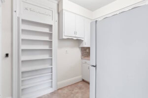 Kitchen featuring white cabinets and open shelving. 2233 NW Flanders St APT 9, Portland, OR 97210. Spaces for rent by NWV Group.