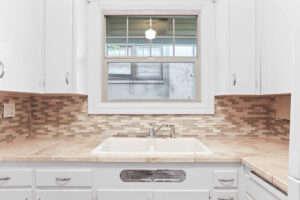 Full kitchen view with white appliances and ample storage. 2233 NW Flanders St APT 9, Portland, OR 97210. Spaces for rent by NWV Group.