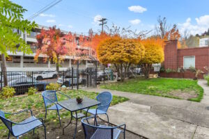 Fenced front yard with greenery and decorative gate. 2233 NW Flanders St APT 9, Portland, OR 97210. Spaces for rent by NWV Group.