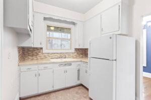 Kitchen with fridge, closet, and tiled flooring. 2233 NW Flanders St APT 9, Portland, OR 97210. Spaces for rent by NWV Group.