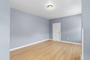 Open room with blue-gray walls and white door. 2233 NW Flanders St APT 9, Portland, OR 97210. Spaces for rent by NWV Group.