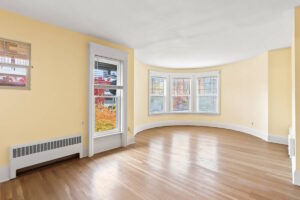 Spacious curved living room with large windows. 2233 NW Flanders St APT 9, Portland, OR 97210. Spaces for rent by NWV Group.